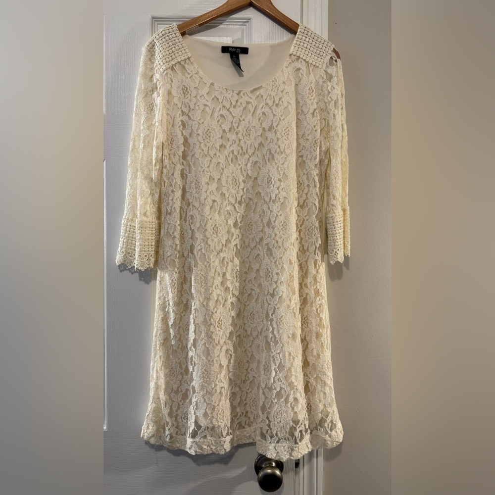 Short Ivory lace dress with a lot of detail.